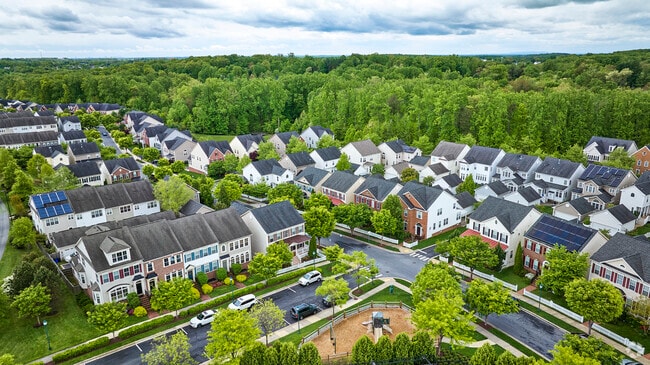 The neighborhoods in Clarksburg, Maryland are all surrounded by green spaces and mature trees.