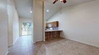 Located at 1759 Sheppard Rees Rd in Kerrville, Texas, this single-story, one-bedroom, one-bathroom home offers a well-designed layout with a warm and functional feel throughout. The home features consistent tile flooring across all rooms, contributing to a clean and cohesive aesthetic.

The kitchen is a standout feature, offering generous counter space with an L-shaped layout, warm oak cabinetry, a tile backsplash, a double sink, a dishwasher, an electric range, and a built-in microwave. Soaring ceilings add an airy quality to the kitchen area, which also includes a breakfast bar with rustic wood panel detailing. A sliding glass door nearby provides access to the backyard, allowing natural light to flow into the living area.

The bedroom is a comfortable, well-proportioned space with high ceilings and a ceiling fan. It connects directly to a spacious walk-in closet outfitted with built-in shelving, wire basket organizers, and hanging rods for ample storage. The full bathroom features a vanity with warm wood cabinetry, a tiled tub-shower combination, and a window for natural ventilation. The layout is rounded out by a hallway that connects the main areas efficiently. This home offers practical, comfortable living in a quiet Kerrville setting.
