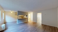 Located at 1600 N San Fernando Blvd in Burbank, California, this two-bedroom, two-bathroom residence offers a practical and comfortable single-floor layout. The open-concept living and dining area is anchored by smooth hardwood-style flooring and a textured ceiling, creating a bright and airy atmosphere. A peninsula-style kitchen divides the living space, featuring gray cabinetry, cream upper cabinets, a gas range, a double sink, and ample counter space — all illuminated by a ceiling-mounted light fixture. The kitchen's efficient U-shaped design maximizes storage and workspace.

Both bedrooms are carpeted and receive natural light through windows. The primary bedroom includes a sliding glass door that opens to a private outdoor area, while the second bedroom features a standard window. Each room offers a calm, neutral palette conducive to relaxation. A dedicated closet provides additional storage within the unit.

The two bathrooms are finished with light tile flooring, and each includes a full tub-shower combination, toilet, and a vanity with storage below. The overall design of the residence is clean and functional, making it a well-organized home in the heart of Burbank.
