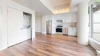 Located at 3030–3060 Pharmacy Ave in Toronto's M1W neighbourhood, this 2-bedroom, 1-bathroom unit offers a thoughtfully designed single-floor layout with modern finishes throughout. Rich hardwood-style flooring flows seamlessly across the open-concept living and kitchen area, creating a warm and cohesive aesthetic. The kitchen is well-appointed with stainless steel appliances — including a refrigerator, stove, and dishwasher — crisp white cabinetry, a subway tile backsplash, and a bright window overlooking the terrace. An in-unit stacked washer and dryer adds convenience. Large floor-to-ceiling windows and sliding glass doors in the living area and both bedrooms flood the space with natural light and provide direct access to a generous tiled terrace, offering open views of the surrounding Toronto skyline and greenery. The primary bedroom features a double closet, while both bedrooms benefit from large windows with terrace views. The bathroom is finished with full-height white tile surrounding a soaker tub. Clean white walls, recessed lighting, and a modern overall palette give the unit a bright, contemporary feel throughout.
