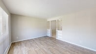 Located at 830 Arlington River Dr in Jacksonville, Florida, this single-floor, one-bedroom, two-bathroom residence offers a practical and well-organized layout. The open living area is finished with light wood-look flooring and neutral-toned walls, creating a bright and welcoming atmosphere. A large window allows natural light to fill the space, while a built-in shelving unit adds functional character to the room. The kitchen features warm-toned wood cabinetry, a double sink with granite-style countertops, tile flooring, and direct access to an exterior door, providing both convenience and natural light. Appliances including a refrigerator and range are included. The spacious bedroom is carpeted for comfort and includes a window overlooking the outdoors, along with a dedicated closet area and a built-in vanity with drawers and a mirror — a practical and thoughtful design feature. A second carpeted room serves as additional flexible space. The two bathrooms include a fully tiled bath and shower combination with a window, alongside a vanity and tile floor. The layout, as seen in the dollhouse view, is efficient and well-connected, making this residence a functional option in a convenient Jacksonville location.