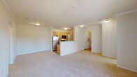 Located in Lafayette, Louisiana, this single-floor, 2-bedroom, 2-bathroom residence features a thoughtfully designed layout that balances comfort and functionality. A carpeted hallway with a distinctive arched entryway leads into the open-concept living and dining area, setting an inviting tone throughout. The living space is generously sized with neutral carpet flooring and crown molding, seamlessly connecting to the kitchen via a peninsula counter that provides both workspace and a casual dining option. The galley-style kitchen is well-appointed with light wood cabinetry, granite-style countertops, hardwood-style flooring, and a full suite of appliances including a stainless steel refrigerator, black range, microwave, and dishwasher. Both bathrooms echo the kitchen's design aesthetic, featuring light wood vanities with granite-style countertops and vessel sinks, and each includes a full tub-shower combination. The bedrooms offer comfortable carpeted flooring, with one bedroom featuring dual windows with a ceiling fan and another with sliding glass door access to a private outdoor area. Crown molding and a consistent neutral color palette throughout contribute to the home's cohesive and polished ambiance.