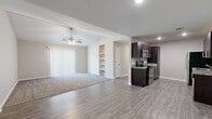 Located at 7900 Moss Creek Dr in Louisville, KY, this single-story, 2-bedroom, 2-bathroom home offers a well-designed layout with a thoughtful blend of modern finishes and comfortable living spaces. The living room features vaulted ceilings with a ceiling fan, plank-style flooring, and a sliding glass door that invites natural light throughout. Built-in shelving adds both function and character to the space. The kitchen is appointed with rich dark cabinetry, granite countertops, a tile backsplash, and a full suite of stainless steel appliances, including a range, microwave, refrigerator, and dishwasher — all centered around light wood-look flooring. The spacious primary bedroom includes a tray ceiling, ceiling fan, plush carpeting, and a window overlooking the outdoors. The second bedroom also features carpet, a ceiling fan, and a mirrored sliding closet door. Both bathrooms are finished with dark vanity cabinetry, granite countertops, and wood-look vinyl flooring. One bathroom features a tub-shower combination and grab bars, while the other offers a walk-in shower setup. Neutral tones and clean finishes are consistent throughout, creating a cohesive and move-in-ready atmosphere.