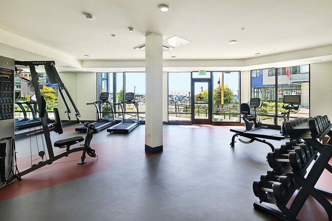 Stay fit in style at our state-of-the-art fitness center, complete with panoramic views. - Waterfront Place