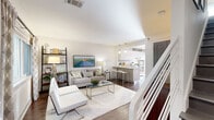 Located in Atlanta's vibrant Virginia-Highland neighborhood, this two-floor residence on Monroe Drive NE offers a thoughtfully designed interior with modern finishes throughout. The main level features an open-concept living and dining area bathed in natural light from large windows dressed with stylish patterned drapes. Rich hardwood floors flow seamlessly from the living space into the kitchen, which is outfitted with white flat-panel cabinetry, granite countertops, a subway tile backsplash, stainless steel appliances including a range, dishwasher, and refrigerator, and a peninsula with bar seating. A staircase with white balusters connects the floors, contributing to the home's clean, contemporary aesthetic. The upper level hosts well-proportioned bedrooms, each featuring ceiling fans, dark-painted double closet doors providing generous storage, and hardwood floors. The bathroom presents a floating wood-toned vanity with a white countertop and vessel sink, complemented by modern pendant lighting and a large mirror. Throughout the residence, a neutral color palette, abundant natural light, and consistent design details create a cohesive and inviting atmosphere well-suited for comfortable urban living.