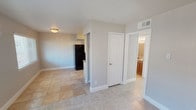 Located at 1025 W Wheatland Rd in Dallas, TX, this single-floor home offers a practical and cohesive layout designed for comfortable everyday living. Light-toned tile flooring flows consistently throughout the entire home, creating a unified and easy-to-maintain interior.

The living area is bright and open, featuring a ceiling fan with integrated lighting and windows fitted with blinds that invite natural light while maintaining privacy. The space provides a welcoming atmosphere with neutral gray walls and clean white trim.

The kitchen is efficiently laid out in a galley style, with warm wood-toned cabinetry lining both sides, a mosaic tile backsplash, granite-style countertops, a stainless steel double sink, and black appliances including an electric range and refrigerator. Ample upper and lower cabinet storage makes the kitchen highly functional.

The bedrooms continue the tile flooring and neutral color palette, each equipped with ceiling fans and windows that allow natural light to fill the rooms. The bathroom features a full tub and shower combo, a wood-toned vanity with granite-style countertops, a large mirror, and matching tile flooring, offering a clean and functional design. Overall, the home presents a well-maintained, move-in ready interior.