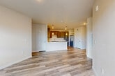 Located in Colorado Springs, CO, this well-appointed 2-bedroom, 2-bathroom residence offers a thoughtfully designed single-floor layout with modern finishes throughout. The open-concept kitchen and living area serves as the heart of the home, featuring gray shaker-style cabinetry, crisp white countertops, a central island with pendant lighting, and a full suite of stainless steel appliances including a refrigerator, range, microwave, and dishwasher. Light wood-look vinyl flooring flows through the main living areas, complementing the bright, neutral color palette. The living room is bathed in natural light from large windows and a glass door that opens to a private balcony, offering sweeping views of the Colorado mountains and surrounding neighborhood. The spacious primary bedroom features plush carpet, ample natural light, a dedicated walk-in closet with built-in shelving and hanging rods, and a private en-suite bathroom. The en-suite bath includes dark cabinetry, a wide vanity, and a full tub-shower combination with tile surround. The second bedroom is generously sized with carpet flooring and bright window views. A second full bathroom mirrors the refined finishes seen throughout. This residence combines comfort and modern style in a desirable Colorado Springs location.