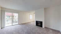Located at 700 W Avenue I in Lancaster, CA, this two-bedroom, two-bathroom residence offers a thoughtfully laid-out single-floor plan designed for comfortable everyday living. The open living area is highlighted by plush carpeting, a ceiling fan, a textured ceiling, and a classic fireplace that serves as a natural focal point. Sliding glass doors lead to a private balcony overlooking the community pool and courtyard, bringing in natural light and pleasant outdoor views. The galley-style kitchen is efficiently designed with white cabinetry, light quartz-style countertops, a stainless steel sink, and white appliances including a gas range and refrigerator, all set atop wood-look flooring. The primary bedroom is a comfortable retreat featuring mirrored sliding closet doors and direct access to an en-suite bathroom. The second bedroom also features carpeting and a sliding double-door closet. Both bathrooms are finished with white cabinetry, light countertops, and tub-shower combinations with wood-look flooring. A hallway connects the rooms, adding to the practical flow of the layout. The residence is part of a well-maintained community with shared amenities including a pool and landscaped common areas.