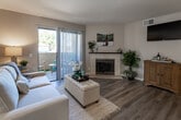 Located on Rancho California Road in Temecula, CA, this single-floor residence offers a well-designed layout with a cohesive blend of comfort and functionality. The living room serves as the centerpiece of the home, featuring rich hardwood-style flooring, a tile-surround fireplace, and large sliding glass doors that flood the space with natural light while providing direct access to a private patio. The outdoor area is visible from the living room, enhancing the sense of openness and connection to the surrounding landscape.

The kitchen is equipped with dark espresso cabinetry, a gas range, over-the-range microwave, and a full-size refrigerator, all complemented by light wood-style flooring. A dining area adjoins the kitchen and living space, creating a practical and connected layout. The bedroom is generously proportioned, featuring plush carpeting, a ceiling fan, and a large window that allows ample natural light.

Two bathrooms serve the residence. One features a dark-cabinet vanity with a wide mirror and wood-style flooring. The second includes a tub-shower combination with a matching dark vanity. Neutral tones and consistent finishes throughout the home create a calm, cohesive ambiance.