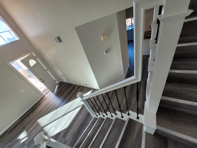 Arch window above door lets in natural light. - 35504 Avenue H