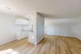 Located at 2585 Hill Tout St, Unit B128 in Abbotsford, BC, this one-bedroom residence offers a well-organized single-floor layout with a bright, clean aesthetic throughout. Light-toned hardwood flooring runs continuously across every room, contributing to a cohesive and modern feel.

The spacious living room is a standout feature, benefiting from large sliding glass doors that open directly onto a private balcony, allowing generous natural light to fill the space. An additional window further enhances the airy atmosphere. Baseboard heating is present throughout, ensuring year-round comfort.

The bedroom is a comfortable, well-proportioned room featuring a large window with curtains that frame outdoor views of the surrounding neighbourhood. A wide sliding closet provides ample built-in storage, while a separate door leads to additional storage or an adjoining space. The room receives excellent natural light.

Throughout the unit, walls are finished in crisp white paint, complemented by clean white baseboards and textured ceilings. The entry area is practical and uncluttered, with a secure front door. The overall design is straightforward and functional, with a neutral palette that offers flexibility for personalization. This unit presents a tidy, move-in-ready space in a residential Abbotsford location.