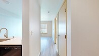 Located at 19501 40th Ave W in Lynnwood, WA, this one-bedroom, one-bathroom unit offers a thoughtfully designed single-floor layout that makes efficient use of its compact footprint. The living area features light-toned laminate hardwood flooring and neutral wall tones, creating a bright and clean atmosphere with an open connection to the kitchen. The kitchen is well-appointed with light wood cabinetry, white countertops, black appliances including a full-size refrigerator and range, and a stainless steel sink — providing all the essentials in a functional U-shaped configuration. The bedroom is carpeted for comfort, features a large window with views of the surrounding building exterior, a baseboard heater, and includes a built-in closet with double bifold doors. The bedroom connects conveniently to the full bathroom, which is finished with a clean, all-white tub and shower surround equipped with an accessibility grab bar and wood-toned flooring. Throughout the unit, warm wood-trimmed door frames, soft neutral walls, and consistent flooring choices lend a cohesive and understated aesthetic. This unit offers a straightforward, livable layout well-suited for individuals or couples seeking a low-maintenance residence in Lynnwood.