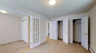 Located at 503 Germantown Pike in Lafayette Hill, Pennsylvania, this single-floor space offers a well-appointed and functional layout designed for comfortable living. The interior is finished with neutral-toned carpeting throughout, lending a warm and cohesive feel to the space.

A standout architectural detail is the elegant French door with a classic multi-pane glass design, framed in crisp white trim with gold hardware accents. This feature adds a refined touch while allowing light to flow between areas and maintaining a sense of openness. The doorways and trim throughout are finished in matching white, creating a clean and consistent aesthetic.

The space is notably well-equipped with storage, featuring multiple closets — including what appear to be double closets with hanging rods — providing generous organization options. The rooms connect naturally, with open doorways that offer a sense of continuity throughout the floor plan.

Ceilings are smooth and finished with a simple flush-mount light fixture, keeping the overall look understated and practical. The neutral wall colors in soft beige and white tones contribute to a bright, airy atmosphere. Overall, this space in Lafayette Hill presents a clean, move-in-ready environment with thoughtful storage solutions and classic design details.