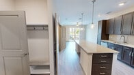Located at Centennial Park Blvd in Alcoa, TN, this well-designed one-bedroom, one-bathroom unit offers a smart and functional layout across a single floor. The kitchen is a standout feature, boasting rich dark cabinetry, granite countertops, a subway tile backsplash, and a full suite of stainless steel appliances including a refrigerator, range, and microwave. A central island with pendant lighting adds both workspace and visual appeal, flowing naturally into the open living area. The living room is bright and airy, with light wood-style flooring, a ceiling fan, and a sliding glass door that opens to a private balcony with outdoor views. The bedroom is a comfortable retreat with soft carpeting, a ceiling fan, a large window for natural light, and direct access to a dedicated closet and the full bathroom. The bathroom features a granite-topped vanity with an undermount sink, dark cabinetry, and tile flooring. A dedicated laundry room with a full-size washer and dryer adds everyday convenience. Neutral tones and clean finishes throughout give the space a fresh, modern character.