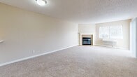 Located at 2481 Grove Way in Castro Valley, California, this single-floor residence offers a clean, functional layout with a bright and neutral aesthetic throughout. The main living area is generously proportioned, featuring smooth hardwood-style flooring, crisp white walls, and a textured ceiling. A large window fitted with vertical blinds allows abundant natural light to fill the space while framing views of the surrounding greenery outdoors.

Adjacent living spaces continue the consistent flooring theme, with additional rooms equipped with ceiling fans for added comfort. One room features a sliding glass door that opens to an outdoor area, further enhancing the connection to natural light and ventilation.

The kitchen is well-appointed with dark espresso-toned cabinetry, granite-style countertops, a built-in dishwasher, electric range, and a stainless steel sink — offering a practical and stylish cooking environment. A black refrigerator completes the kitchen suite.

A hallway connects the bedroom areas to a full bathroom, which includes a vanity with cabinet storage, a toilet, and a shower-tub combination. A linen closet is conveniently located nearby. The overall layout is efficient and well-connected, with each room flowing naturally into the next through a cohesive interior design.