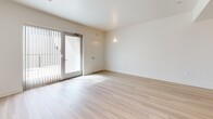 Located at 521 W Colorado St in Glendale, CA, this well-designed one-bedroom, one-bathroom residence offers a clean, modern aesthetic throughout. The open-concept living and kitchen area is anchored by light wood-tone flooring that extends across the main living space, creating a bright and cohesive feel. Large sliding glass doors in the living room invite abundant natural light and provide direct access to the outdoors. The kitchen is thoughtfully outfitted with white shaker-style cabinetry, warm wood-toned countertops, stainless steel appliances including a refrigerator, range, microwave, and dishwasher, as well as a skylight that further brightens the space. The bedroom features plush carpeting, a generous closet, and a window framing scenic views of the surrounding Glendale cityscape and mountains. The full bathroom is finished with large-format tile flooring and includes a tub-shower combination. Additional conveniences include an in-unit laundry area and dedicated closet storage. The overall design palette of crisp white walls, neutral tones, and clean lines gives the space a fresh, contemporary character well-suited for comfortable urban living in the heart of Glendale.