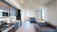 Located at 625 North 2nd Avenue in downtown Phoenix, AZ, this thoughtfully designed one-bedroom, one-bathroom unit offers a compact yet highly functional living space across a single floor. The open-concept layout seamlessly connects the kitchen, dining, and living areas, making efficient use of every square foot.

The kitchen is outfitted with dark cabinetry, stainless steel appliances including a gas range, microwave, dishwasher, and full-size refrigerator, complemented by a white tile backsplash and light countertops. The living area benefits from floor-to-ceiling windows that flood the space with natural light and frame sweeping views of the Phoenix skyline and surrounding neighborhood.

The bedroom is a private, well-proportioned retreat featuring its own floor-to-ceiling window with expansive city views, a built-in closet, and an exposed concrete ceiling that adds an industrial character consistent throughout the unit. Light wood-tone flooring runs throughout the main living areas, lending warmth to the modern aesthetic.

The bathroom is finished with large-format tile flooring, a floating wood vanity with a white countertop, an illuminated mirror, and matte black fixtures. Additional spaces include an entrance foyer, a dedicated closet, and in-unit laundry, ensuring practical everyday convenience in this urban residence.