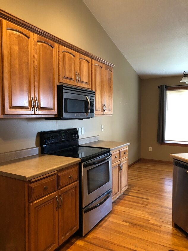 We love the wood floors in the kitchen & dining areas, with vaulted ceilings! - 911 N Bahnson Ave