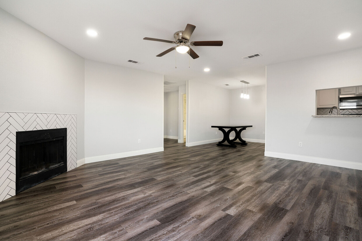 Open living room and dining area with window into the kitchen - 4302 Forest Point Dr