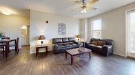 This 890 square foot apartment in Odessa, Texas, offers a well-designed living space with two bedrooms and two bathrooms. The open floor plan maximizes the use of space, creating a seamless flow between the living areas. The apartment features wood flooring throughout, adding warmth and durability to the space.

The living room is bright and airy, with large windows allowing ample natural light. It's furnished with comfortable leather sofas and a flat-screen TV, perfect for relaxation. The adjacent kitchen boasts modern stainless steel appliances, white cabinetry, and a spacious granite countertop island, ideal for meal preparation and casual dining.

The primary bedroom, measuring 190 square feet, is generously sized and features plush carpeting, multiple windows, and a ceiling fan for comfort. Both bedrooms are equipped with ample closet space and coordinating wood furniture.

The bathrooms are well-appointed with granite countertops, modern fixtures, and a combination of wood flooring and tiled shower areas. One bathroom includes a bathtub with a shower curtain, while the other features a walk-in shower.

Throughout the apartment, neutral wall colors and strategic lighting create a bright, welcoming atmosphere. The property also includes modern amenities such as in-unit laundry facilities and central air conditioning, ensuring a comfortable living experience in this efficiently designed space.