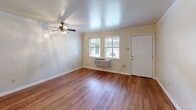 Located at 3401 Garden Oaks Dr in New Orleans, LA, this single-floor, 1-bedroom, 2-bathroom residence offers a practical and comfortable layout designed for efficient living. The living room serves as the heart of the home, featuring warm hardwood-style flooring that runs throughout the unit, crown molding, and a ceiling fan with light fixture. Natural light filters in through windows fitted with blinds, creating a bright and inviting atmosphere. The space flows openly into the adjoining areas, giving the home an airy feel despite its cozy footprint.

The kitchen is accessible via a charming pass-through window with a built-in ledge, ideal for casual dining or serving. It is equipped with light wood cabinetry, granite-look countertops, a white electric range, and a refrigerator, providing all the essentials in a compact, well-organized space.

The bedroom offers a comfortable retreat with its own ceiling fan, hardwood-style flooring, crown molding, a window with natural light, and a wall-unit HVAC system for year-round comfort. A closet provides dedicated storage. The two bathrooms are clean and functional, one featuring a full tub-shower combination with tiled surround, and a vanity with a mirrored medicine cabinet. Textured walls add a subtle design detail throughout the bathrooms.