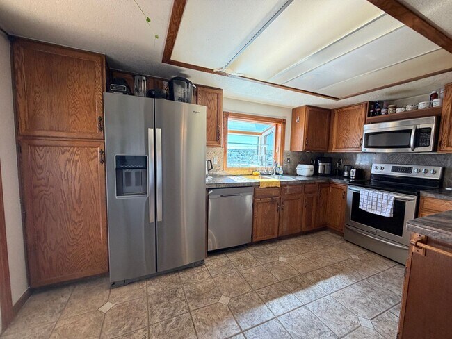 Building Photo - Entertainer’s Paradise Backing to Open Space with Waterfall, Decks & Walk-Out Basement