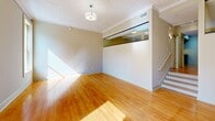 Located at 1601 Main St in downtown Columbia, SC, this single-floor, one-bedroom, two-bathroom unit offers a well-organized layout across a generously sized footprint. The living area is immediately inviting, showcasing warm honey-toned hardwood floors that carry throughout much of the space, abundant natural light, and a distinctive interior glass transom window that adds an architectural accent and visual openness to the main room. A staircase is also visible, adding a subtle design element to the living space.

The kitchen is efficiently designed with ample upper cabinetry in a neutral taupe finish, granite-style countertops, a stainless steel double sink, and black appliances including a refrigerator, dishwasher, and electric range — all set atop the same hardwood flooring.

The expansive primary bedroom offers generous proportions with continued hardwood flooring, neutral wall tones, and access to a dedicated closet. The hallway connects the rooms with a clean, open flow.

Both bathrooms are finished with slate-blue tile flooring. One features a walk-in shower with chrome fixtures, while the other includes a full soaking tub with a shower curtain rod. Warm beige walls and clean white fixtures give both bathrooms a practical yet polished appearance throughout.