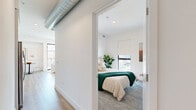 Located at 10401 Washington Blvd in the heart of Culver City, this modern 1-bedroom, 1-bathroom unit offers a thoughtfully designed layout across a single floor. The open-plan living and kitchen area serves as the heart of the home, featuring light hardwood flooring, recessed lighting, and large floor-to-ceiling sliding glass doors that flood the space with natural light and provide views of the surrounding neighborhood, including glimpses of palm trees and the iconic Culver City skyline.

The kitchen is outfitted with sleek white flat-front cabinetry, a textured tile backsplash, quartz countertops, stainless steel appliances including a gas range and refrigerator, and a dedicated dining nook. Exposed industrial-style ductwork adds a contemporary loft-like character to the space.

The bedroom offers a cozy, carpeted retreat with a window overlooking the street, a closet, and a calm, bright atmosphere. The bathroom features a glass-enclosed walk-in shower, wall-mounted toilet, and clean white finishes. An entrance area connects all rooms efficiently, maximizing the unit's well-proportioned footprint for comfortable urban living.