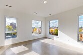 Located at 3740 Second Ave in Detroit's Midtown neighborhood, this thoughtfully designed one-bedroom, one-bathroom unit showcases a clean, contemporary aesthetic throughout. Polished concrete floors run seamlessly across the entire space, reflecting natural light and lending an industrial-modern character to every room.

The open-plan living and dining area is defined by an abundance of large windows that frame sweeping views of the Detroit cityscape and surrounding tree-lined streets, filling the space with natural light. The kitchen flows directly from the living area and features light wood cabinetry, white quartz countertops, a subway tile backsplash, and a full suite of stainless steel appliances including a gas range, dishwasher, refrigerator, and microwave.

The bedroom is a well-proportioned retreat offering two double-door closets for generous storage, along with windows that invite in ample daylight and city views. An additional closet elsewhere in the unit provides further storage flexibility, and a dedicated laundry area adds everyday convenience.

The bathroom is finished with warm-toned tile, a walk-in shower with white subway tile surround, a light wood vanity, and a white countertop. The overall palette of crisp whites, natural wood tones, and polished concrete creates a cohesive, modern living environment.