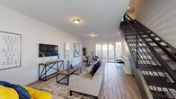 This two-story home is thoughtfully designed with a clean, modern aesthetic throughout. The main floor features an open-concept layout where the living room, dining area, and kitchen flow seamlessly together. The living room is bright and welcoming, finished with wood-look flooring and offering direct access to an outdoor patio through sliding glass doors. A convenient half bathroom is also located on the main floor. The kitchen is well-equipped with white shaker cabinetry, grey tile backsplash, stainless steel appliances including a refrigerator and dishwasher, recessed lighting, and light hardwood flooring. The dining area sits adjacent to the kitchen, providing an inviting space for meals. A staircase with metal railings leads to the upper level, where the bedrooms are located. The primary bedroom is generously sized with plush carpeting, a large sliding glass door with vertical blinds allowing abundant natural light, and a spacious walk-in closet outfitted with multiple shelving rods. Additional bedrooms are carpeted and well-lit with natural light from windows. The upper level also includes a full bathroom with a soaking tub and shower combination, white vanity, and wood-look tile flooring. Throughout the home, the neutral white walls and consistent finishes create a cohesive and airy atmosphere.