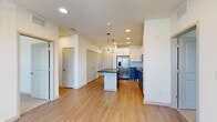 Located at 4000 Dr Walter S Davis Blvd in Nashville, TN, this well-appointed 2-bedroom, 2-bathroom residence offers a thoughtfully designed single-level layout. The open-concept living area seamlessly connects the kitchen, dining, and living spaces, all finished with durable wood-style flooring and recessed lighting throughout. The kitchen is a standout feature, showcasing a large center island with dark countertops, white upper cabinetry, contrasting navy-blue lower cabinets, a classic subway tile backsplash, and a full suite of stainless steel appliances including a French door refrigerator, range, microwave, and dishwasher. Pendant lights above the island add a modern touch. The living area extends toward large windows that invite natural light and offer outdoor views. Both bedrooms are carpeted and feature ceiling fans and windows with neighborhood views. The primary bedroom includes a spacious walk-in closet with wire shelving. Each bathroom is finished with wood-style flooring, white shaker cabinetry, dark countertops, and large mirrors. One bathroom offers a glass-enclosed walk-in shower, while the other includes a soaking tub. Additional highlights include three closets, a dedicated laundry area, and a utility room.