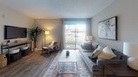 Located on Ellington Circle in Nashville, Tennessee, this single-floor residence offers a thoughtfully designed layout with a warm, contemporary aesthetic throughout. The living room serves as the heart of the home, featuring wood-style flooring, neutral toned walls, and a large sliding glass door that floods the space with natural light and provides direct access to an outdoor patio. The open, airy atmosphere is complemented by a textured ceiling and ample room for comfortable furnishings.

Adjacent to the living area is a dedicated dining space, ideal for intimate gatherings, with enough room for a round table and seating. The kitchen is efficiently designed with white cabinetry, granite-style countertops, a classic subway tile backsplash, stainless steel appliances, and wood-style flooring — combining both style and functionality.

The bedrooms are carpeted and well-proportioned, each offering natural light through windows dressed with curtains and blinds, creating a calm and restful environment. The bathroom is cleanly finished with a tiled tub-shower combination, marble-style countertop, and neutral wall tones that contribute to an overall sense of freshness. Throughout the residence, a cohesive neutral palette and modern finishes create a welcoming and move-in-ready living environment.