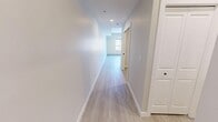 Located on the sixth floor at 829 17th Ave SW in Calgary's lively Mission neighbourhood, this one-bedroom, one-bathroom unit offers a thoughtfully designed layout that maximizes every square foot. A clean, well-lit entryway corridor with light wood-look flooring and recessed lighting guides residents into the main living area, setting a bright and modern tone throughout.

The open-concept kitchen is a standout feature, outfitted with light wood cabinetry accented by matte black hardware, crisp white lower cabinets, and white quartz-style countertops. A full suite of stainless steel appliances — including a refrigerator, electric range, and dishwasher — provides practical functionality. A window adjacent to the kitchen brings in natural light and city views, enhancing the airy feel of the living space.

The bedroom is a cozy, dedicated retreat finished in neutral tones with baseboard heating and light flooring consistent with the rest of the unit. The bathroom features a clean, contemporary design with a combined tub and shower, a white vanity with an integrated sink, and matte black fixtures for a modern accent. Throughout the unit, a neutral colour palette, light flooring, and consistent modern finishes create a cohesive and inviting atmosphere well-suited to urban living.