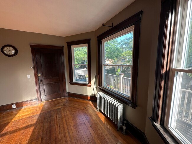 Double living room with bay window and second-story porch - 43 Pitman St