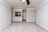 Located at 1615 N Cobb Pkwy in Marietta, Georgia, this single-floor residence offers a well-designed layout with a cohesive blend of comfort and modern finishes throughout. The living area is generously proportioned, featuring plush carpeting, crown molding, a ceiling fan, and French doors that invite natural light and provide outdoor access. A pass-through window connects the living space to the kitchen, enhancing the open feel between rooms.

The kitchen is outfitted with stainless steel appliances — including a refrigerator, range, and dishwasher — complemented by white cabinetry, granite-style countertops, and wood-look flooring that extends through the dining area. A pendant light fixture adds a finishing touch to the dining space.

The bedrooms are carpeted and well-lit by natural light through standard windows, each equipped with ceiling fans. The primary bedroom includes direct access to a full bathroom featuring a granite-topped vanity with white cabinetry, a large mirror, and a tub-shower combination. A spacious walk-in closet with wire shelving provides ample storage. An additional half bath with a pedestal sink and oval mirror serves guests. The layout flows efficiently, making this a functional and inviting single-floor residence.