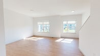 This well-designed three-story home offers four bedrooms and four bathrooms, providing ample space across its multiple levels. The ground floor houses an attached garage with drywall finishes and interior access, along with a connecting hallway and staircase. The main living floor features a bright, open living room finished with light hardwood flooring and crisp white walls, bathed in natural light from multiple large windows with roller shades that frame views of the surrounding greenery. The kitchen is well-appointed with rich dark cabinetry, granite countertops, a central island, stainless steel appliances, and a sink — all complemented by light hardwood flooring and a window overlooking the outdoors. The upper floor hosts the bedrooms, each carpeted and filled with natural light through generously sized windows. The primary bedroom includes a walk-in closet with built-in shelving. The bathrooms feature hardwood-style flooring, granite-topped dark wood vanities, and full bathtub-shower combinations with clean white surrounds. Staircases with white railings connect all three levels seamlessly, and the consistent use of neutral tones, clean lines, and quality finishes throughout creates a cohesive, modern aesthetic.