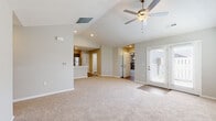 Located at 6400 Birch Trail Ln. in Columbus, Ohio, this single-story home offers a well-designed, open layout with a clean, neutral aesthetic throughout. The main living area features vaulted ceilings with recessed lighting and a ceiling fan, creating a bright and airy atmosphere. Soft carpeting extends across the living and bedroom spaces, while light-toned walls contribute to a welcoming, cohesive feel. French doors in the living area invite natural light and provide outdoor access. The kitchen is well-appointed with rich, dark gray shaker-style cabinetry, light granite countertops, wood-look flooring, and a full suite of stainless steel appliances including a refrigerator, range, and over-the-range microwave. The bedrooms are generously proportioned with plush carpeting and windows that bring in natural light. The bathrooms feature elegant marble-look tile flooring; one includes a stylish vanity with a white countertop and a glass-enclosed shower, while the second offers a tub and shower combination. The spacious attached two-car garage provides ample storage and parking. Overall, the home presents a move-in-ready interior with modern finishes and a practical, comfortable single-floor layout.