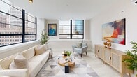 Located in the heart of downtown Hartford at 31 Pratt St, this thoughtfully designed one-bedroom, one-bathroom residence offers a bright and modern living experience across a single floor. The open-concept living and kitchen area is anchored by striking floor-to-ceiling black-framed windows that flood the space with natural light and frame expansive views of the Hartford skyline. Light wood-tone flooring runs throughout the main living areas, complementing the clean, neutral palette.

The kitchen is outfitted with white shaker cabinetry, quartz countertops, a white subway tile backsplash, stainless steel appliances including a range, microwave, refrigerator, and dishwasher, and matte black hardware for a refined, contemporary touch. A large window also brightens the kitchen, reinforcing the home's connection to the urban surroundings.

The bedroom offers a comfortable, carpeted retreat with its own city-facing window equipped with roller shades, providing both natural light and privacy. A wall-mounted mini-split HVAC unit ensures individual climate control in both the bedroom and living room.

The bathroom features a white vanity with under-mount sink, tile flooring, and a walk-in shower. Throughout the residence, the design balances modern functionality with an inviting, urban aesthetic.