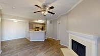 Located in Dallas, TX, this single-story 2-bedroom, 2-bathroom home offers a well-designed layout that maximizes functionality and comfort. The open-concept living, dining, and kitchen area serves as the heart of the home, featuring wood-look flooring, crown molding, and a ceiling fan. A tile-surround fireplace with a classic white mantel anchors the living room, while a sliding glass door floods the space with natural light and provides access to the patio. The kitchen features gray cabinetry, light quartz-style countertops, stainless steel appliances including a range and microwave, and a dishwasher — all centered around a convenient breakfast bar peninsula. Both bedrooms are well-proportioned, with the spacious primary bedroom offering ample closet space. The bathrooms are finished with gray vanity cabinetry and modern lighting fixtures. A dedicated laundry area with upper storage cabinets adds everyday convenience. A hallway connects the main living spaces to the bedrooms and bathrooms, keeping the layout efficient and private. The attached garage provides secure parking and additional storage. With six closets throughout, this home delivers excellent storage capacity for its size.