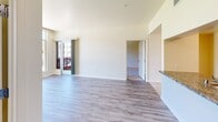 Located at 195 Page Mill Rd in Palo Alto, CA, this well-appointed 2-bedroom, 2-bathroom residence offers a thoughtfully designed single-floor layout. The open-concept kitchen and living area serves as the heart of the home, featuring light tile flooring, two-tone cabinetry with dark lower and white upper cabinets, granite countertops, and full appliances including a range and dishwasher. The living room extends naturally from the kitchen, highlighted by wide-plank hardwood-style flooring and a sliding glass door that opens to an outdoor balcony, flooding the space with natural light.

Both bedrooms are carpeted and feature large windows that bring in ample daylight and views of the surrounding community. The primary bedroom is generously sized and includes a mirrored sliding closet. The second bedroom is equally bright, with wide windows framing outdoor views.

The two bathrooms are finished consistently with tile flooring, dark wood vanities, granite countertops, and framed mirrors. One bathroom features a frameless glass-enclosed walk-in shower with tiled surround, while the other offers a clean, functional layout. A hallway connects the main living spaces to the bedrooms and bathrooms, providing a practical and efficient floor plan throughout.
