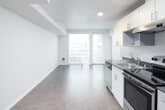 Located in Seattle's Capitol Hill neighborhood at 1500 12th Avenue, Unit 514 is a one-bedroom, one-bathroom residence designed with a clean, contemporary aesthetic throughout. The single-floor layout is efficiently arranged, with an open-concept living and kitchen area that maximizes usable space and promotes a sense of openness.

The kitchen runs along one wall and is outfitted with stainless steel appliances, including an electric range with overhead ventilation, a refrigerator, and a sink. White cabinetry extends to the ceiling, providing generous storage, while dark countertops offer a subtle contrast. The kitchen transitions seamlessly into the living area, which features hard-surface flooring and neutral white walls that lend a bright, versatile backdrop.

A large window in the living area allows natural light to fill the space and frames views of the surrounding Seattle cityscape, creating a pleasant connection to the urban environment outside. Recessed lighting complements the natural light throughout.

The bedroom is a well-proportioned private space with its own window and hard-surface flooring, offering a quiet retreat within the unit. The bathroom features a full tub and shower combination, a white vanity with under-sink storage, a large mirror, and tile flooring, all finished in a clean, minimal style consistent with the rest of the unit.