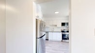 Located in the established Sir John's Homestead neighbourhood of Mississauga, this three-bedroom, one-bathroom home is spread across three floors, offering a well-organized and functional layout throughout. The main level features a bright living room with large windows that bring in generous natural light and offer views of the surrounding greenery, complemented by light wood laminate flooring and clean white walls that carry throughout the home. The kitchen is thoughtfully updated with white shaker-style cabinetry, a subway tile backsplash, dark countertops, and a full suite of stainless steel LG appliances including a dishwasher, electric range, and over-the-range microwave. The upper floors host three bedrooms, including a spacious primary bedroom, all featuring light wood flooring, neutral tones, and windows that allow for ample natural light. The bathroom is finished with crisp white subway tile surrounding the bathtub and shower combination, paired with wood-look flooring for a clean, modern aesthetic. The lower level includes a utility room with laundry facilities and additional unfinished space. A staircase with black metal railings connects the floors, adding a subtle contemporary touch to the interior.