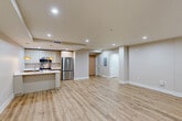 Located at 625 Jackson Ave in New Orleans, LA, this thoughtfully designed one-bedroom, one-bathroom residence offers a generous and well-appointed single-floor layout. Light wood-style flooring flows seamlessly throughout, complementing the neutral warm-beige walls and clean white baseboards that give the space a fresh, contemporary feel.

The open-concept living, dining, and kitchen area forms the heart of the home, providing an expansive and versatile space for both everyday living and entertaining. The kitchen is outfitted with stainless steel appliances — including a full-size refrigerator, electric range, and built-in microwave — paired with two-tone cabinetry featuring white upper cabinets and warm wood-toned lower cabinets, all topped with crisp white countertops. A kitchen island adds additional prep and seating space.

The spacious living area is highlighted by a sleek ceiling fan, recessed lighting, and a pair of tall black-framed windows that bring in natural light. A whitewashed brick accent wall adds a nod to New Orleans character.

The generously sized primary bedroom offers ample room and is serviced by three closets for abundant storage. The bathroom features a glass-enclosed walk-in shower, a wood-toned vanity with stone countertop, and tile flooring. A hallway connects the private and common areas efficiently, completing this well-planned residence.