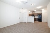 This contemporary 840 square foot apartment offers a thoughtfully designed living space with two bedrooms and two bathrooms. The open-concept layout seamlessly integrates the living room and kitchen, creating a spacious feel. The kitchen is equipped with modern appliances, including a built-in microwave, and features ample cabinetry in a neutral tone. Light-colored countertops complement the overall design.

Throughout the apartment, wood-look flooring adds warmth and durability. The primary bedroom, measuring 140 square feet, provides a generous space for relaxation. Both bedrooms feature ceiling fans and windows that allow natural light to flood in. The bathrooms are efficiently designed with modern fixtures and include bathtub-shower combinations.

The apartment's neutral color palette, predominantly in soft whites and beiges, creates a clean and versatile canvas for personal decor. Recessed lighting and pendant fixtures provide ample illumination. A notable feature is the presence of closet space, including a walk-in closet, offering practical storage solutions.

Located at 307 E Hawaii Ave in Nampa, Idaho, this single-story residence combines comfort and functionality in a well-planned layout, ideal for modern living.