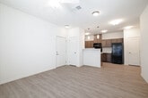 Located at 307 E Hawaii Ave in Nampa, Idaho, this single-floor, 2-bedroom, 2-bathroom residence offers a practical and well-organized layout designed for comfortable everyday living. Light wood-style flooring flows consistently throughout, complementing the neutral, warm-toned walls and creating a clean, cohesive aesthetic.

The open-concept kitchen and living area serves as the heart of the home. The kitchen features warm taupe cabinetry with ample upper and lower storage, light stone-look countertops, a double-basin sink, and black appliances including a range, microwave, and refrigerator. A peninsula with pendant lighting provides additional counter space and separates the kitchen from the living area. A dedicated pantry adds further storage convenience.

The primary bedroom is a comfortable, well-proportioned retreat with a ceiling fan and a window that allows natural light to filter in. Its en-suite bathroom includes a vanity with storage cabinetry and leads directly into a spacious walk-in closet with built-in shelving and hanging rods. The second bedroom is equally bright, and the second full bathroom features a tub-shower combination with tiled surround.

Additional highlights include a dedicated laundry area, a private patio, and a total of six closets throughout the home, ensuring exceptional storage capacity for residents.