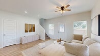 Located at 4900 Tyler Ave in McAllen, TX, this two-story home offers a thoughtfully designed layout spread evenly across two floors. The main level opens into a bright, airy living room with light wood-look flooring, a ceiling fan, and multiple windows that invite natural light. The open-concept kitchen is a standout feature, showcasing a large center island with seating for four, warm wood-toned lower cabinetry paired with light upper cabinets, a white subway tile backsplash, stainless steel appliances, and stylish pendant lighting overhead.

Upstairs, the primary bedroom is a comfortable retreat with a ceiling fan, a generous walk-in closet with built-in shelving, and warm wood-look flooring that carries throughout the home. The second bedroom is equally well-appointed, featuring dual windows with outdoor views and its own ceiling fan. Both rooms are finished in neutral tones that create a calm, restful ambiance.

The three bathrooms are elegantly finished, with one featuring floor-to-ceiling marble-look tile in the glass-enclosed walk-in shower, complemented by wood-look flooring and a clean vanity. Additional bathrooms provide tub and shower options. The staircase connects both levels seamlessly, completing this well-balanced and modern home.