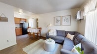 Located at 2410 S Mission Rd in Tucson, Arizona, this compact and well-organized one-bedroom, one-bathroom unit makes smart use of its space across a single floor. The open-concept layout seamlessly connects the living area and kitchen, creating an inviting and functional flow throughout. Wood-style flooring runs through the main living spaces, adding warmth and visual continuity.

The living room offers a comfortable, well-lit area with a window unit for climate control and natural light filtering in through vertical blinds. A wall-mounted TV area near the entry adds a practical touch to the space. The kitchen features warm-toned wood cabinetry, granite-style countertops, a stainless sink, and a full-size refrigerator, with a bright window providing additional natural light. A dedicated dining area sits adjacent to the kitchen.

The bedroom is carpeted for comfort and includes a wall-mounted AC unit, a natural light-filled window, and direct access to a walk-in closet. A second closet provides additional storage elsewhere in the unit. The bathroom is neatly appointed with wood cabinetry, a granite-style vanity top, a full tub with shower, and wood-style flooring. A textured ceiling finish is consistent throughout the unit, adding a classic character to this practical Tucson residence.