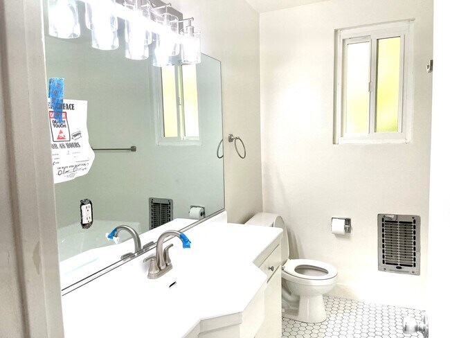 renovated bathrooms with modern cabinetry - 605 S Barrington Ave
