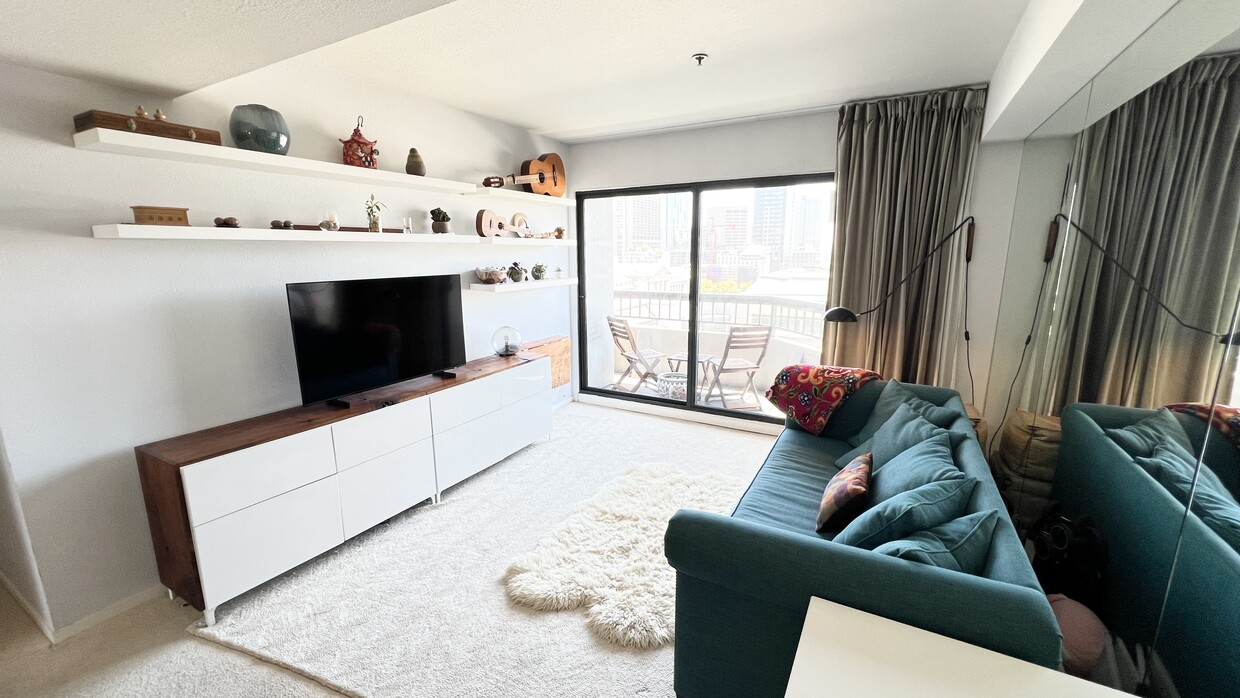 Living room - includes walnut counter and desk, shelving, lighting fixture, and window treatments - 601 Van Ness Ave