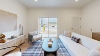 Located at 15 Ore Bank Road in Dillsburg, PA, this single-floor residence offers a thoughtfully designed 2-bedroom, 2-bathroom layout that balances comfort and functionality. The open-concept kitchen and living area serves as the heart of the home, featuring light hardwood-style flooring, recessed lighting, and a seamless flow between spaces. The kitchen is outfitted with gray shaker-style cabinetry, white quartz countertops, stainless steel appliances, and a peninsula island with pendant lighting overhead — ideal for both cooking and casual dining. The living room extends naturally from the kitchen and includes a sliding glass door that fills the space with natural light and provides outdoor views. The generously sized primary bedroom features plush carpeting, a window for natural light, a walk-in closet, and a private en-suite bathroom. The second bedroom also offers comfortable proportions and carpeted flooring. Both bathrooms are finished with gray vanities, white countertops, and hardwood-style tile flooring. A hallway with additional closet storage connects the private quarters to the main living areas. Clean white walls, black hardware accents, and consistent finishes throughout create a cohesive, modern aesthetic across the entire residence.